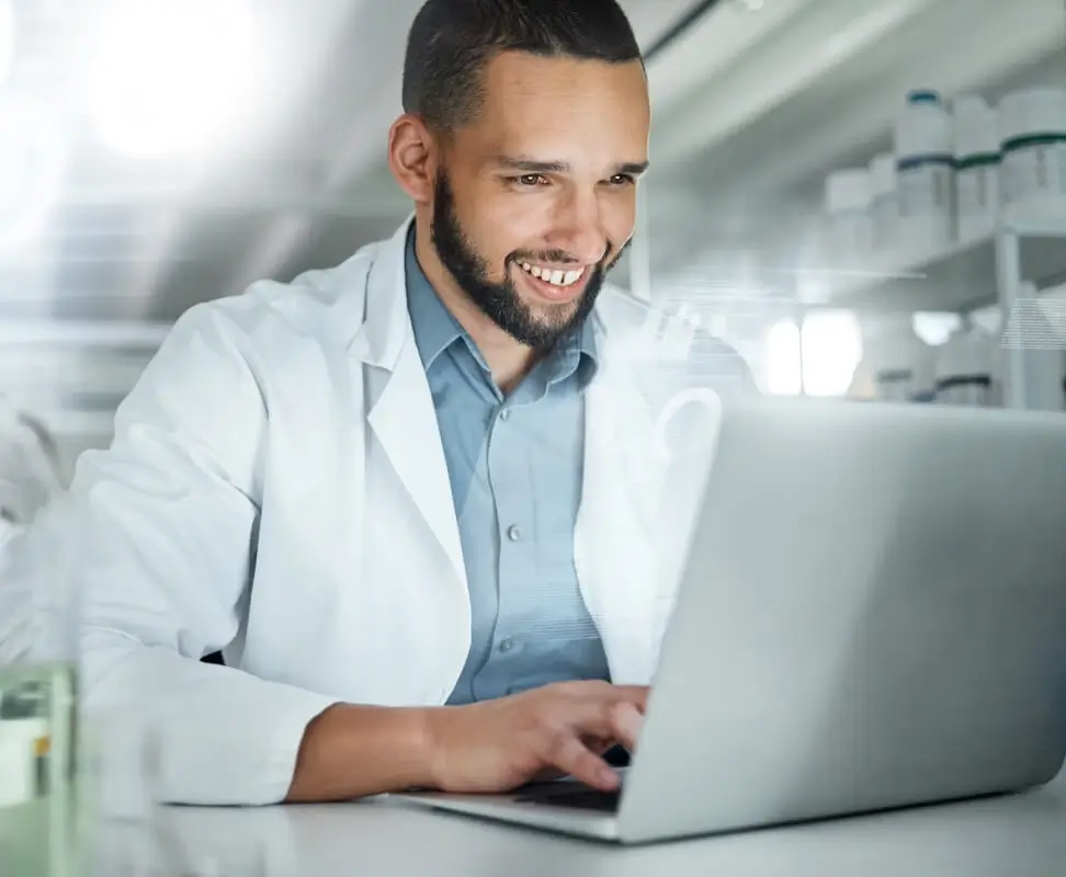 Scientist checking test results on a laptop.