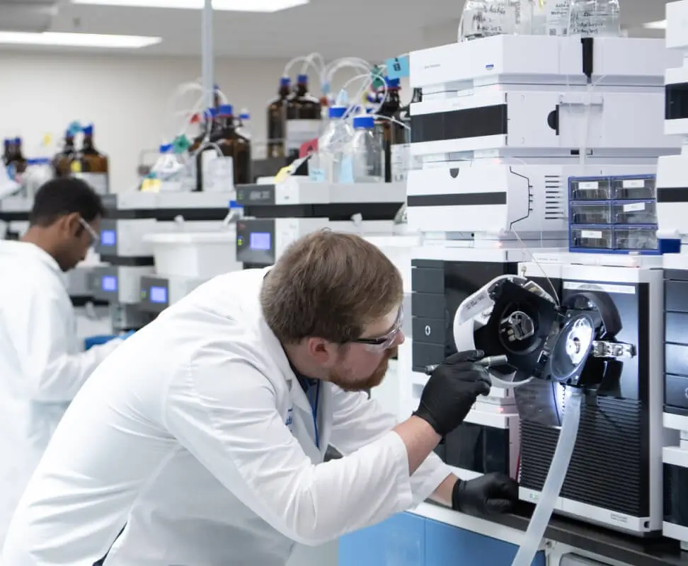 Scientists interacting with Infinity Laboratories equipment