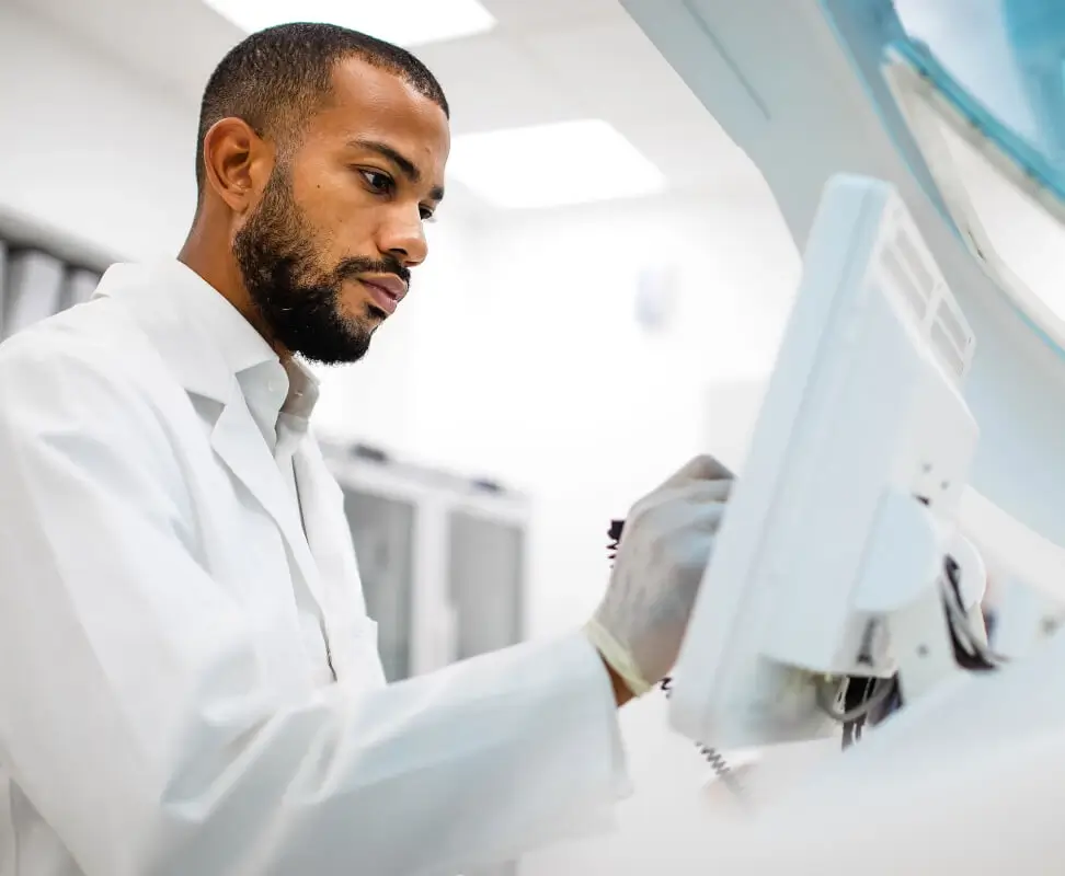 Scientist running tests on a touchscreen interface.