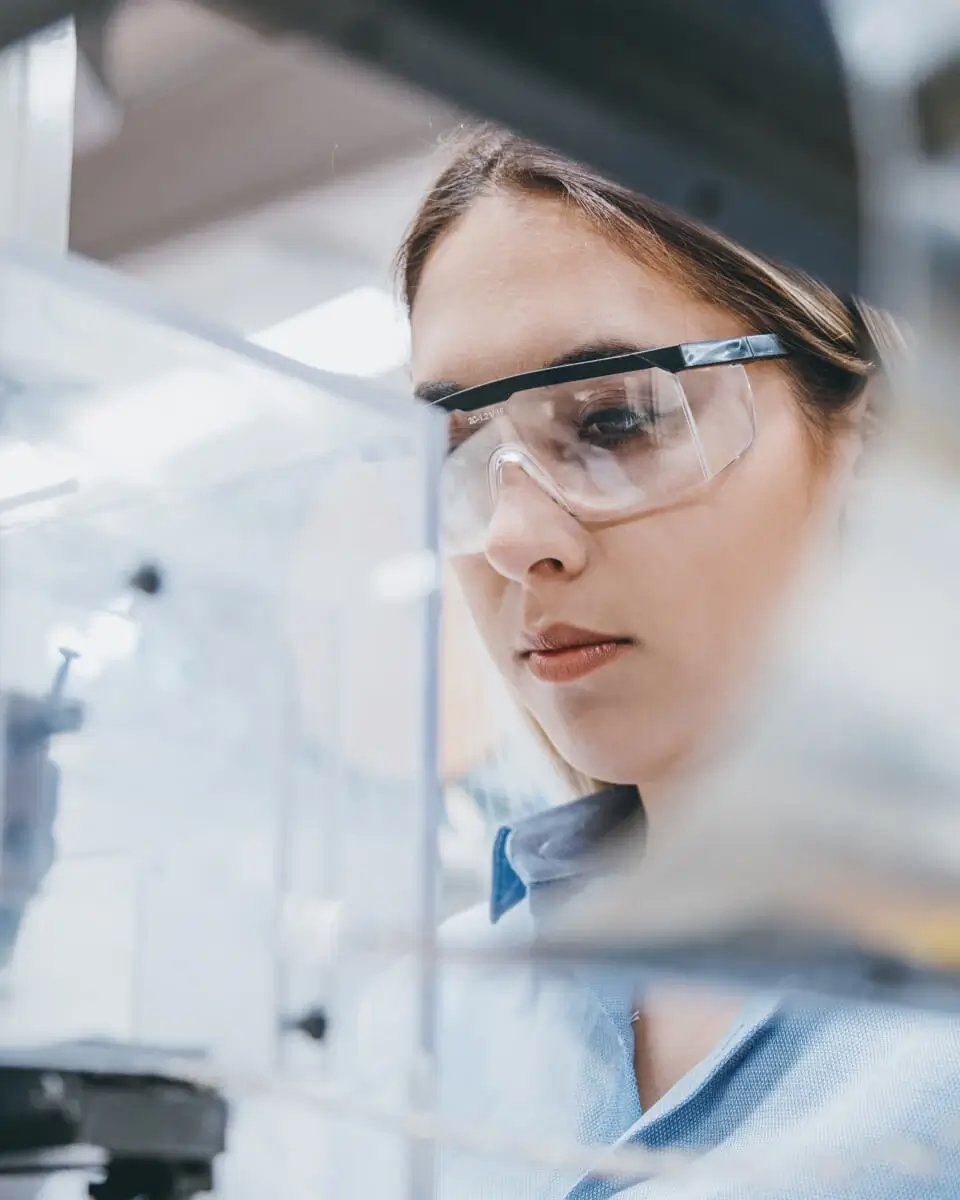 Female scientist examening a medical device